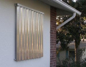 Aluminum shutters help protect windows from flying debris during windstorms. 