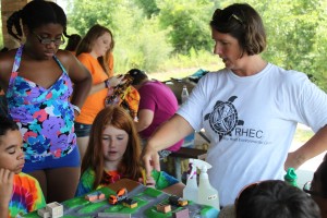 Volunteer helping 4-H'ers with outdoor education class