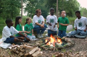 4-H youth around a campfire