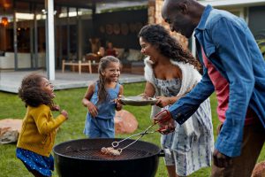 family around a grill