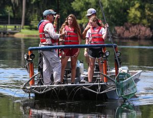 youth on a boat wearing life jackets