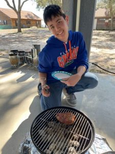 Young man grilling pork chops