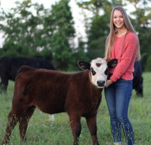 girl holding calf