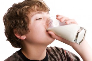 Young boy drinking a glass of milk