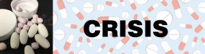 small round pink pills and oblong white pills with round pill box on pill banner with the word CRISIS