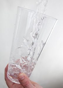 hand holding a glass of water