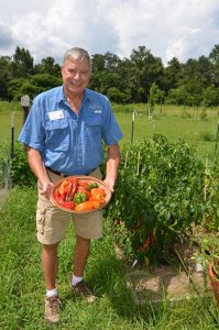 Wakulla Master Gardener Bill Osborne shows off some of the peppers he grew.