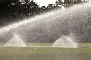 Sprinklers watering athletic field