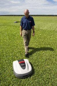 UF/IFAS Extension Turfgrass Researcher Dr. Bryan Unruh with robotic mower