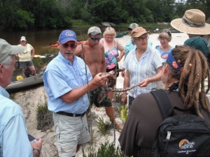 Rick O'Connor shows non-venomous snake to kayakers on recent field trip.