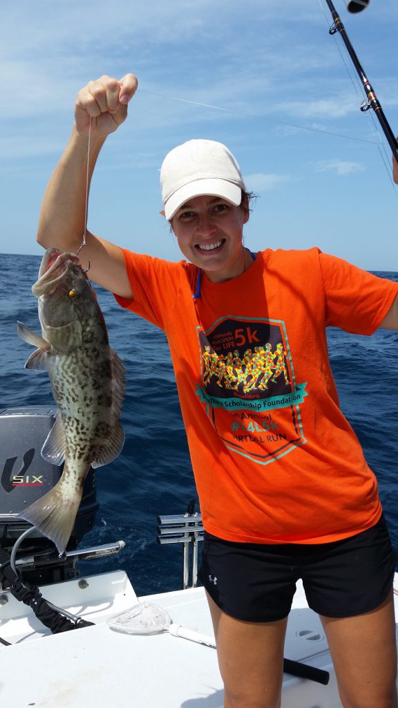 girl with grouper on line