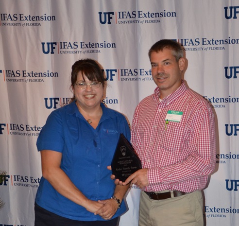 Libbie Johnson, Escambia County Extension presented the Ag innovator Award to Brent Yoder.
