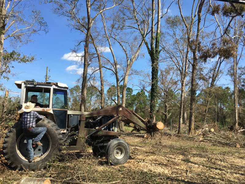 Tractor clearing debris